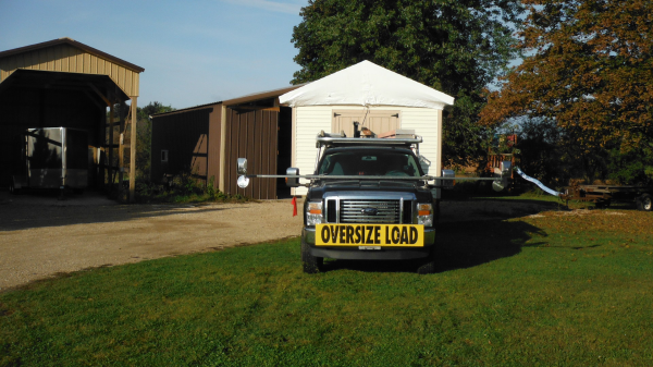 Storage shed moving with truck and trailer